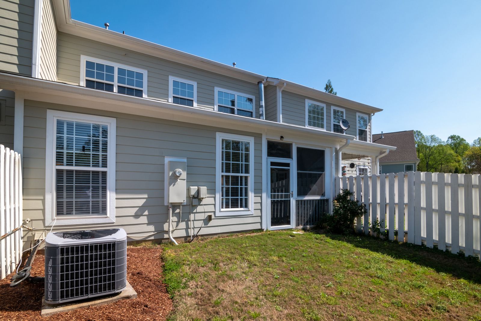 Two-story home with grey lap siding, white trim and a covered entry